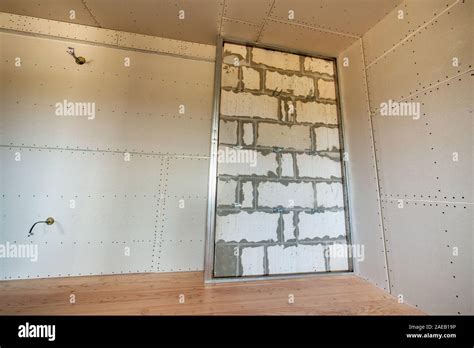 Unfinished Brick Wall In A Room Under Construction Prepared For Drywall