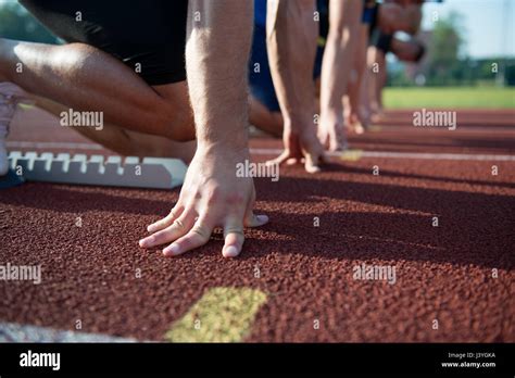 Runners Preparing For Race At Starting Blocks Stock Photo Alamy