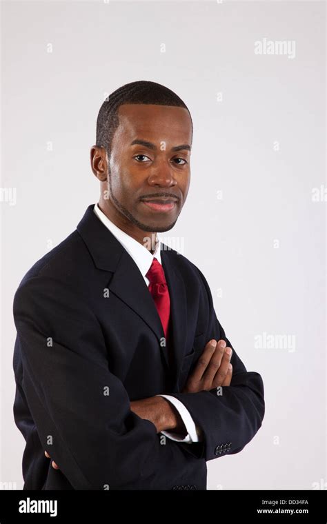 Handsome Black Businessman In A Dark Suit And Red Tie Sitting With His