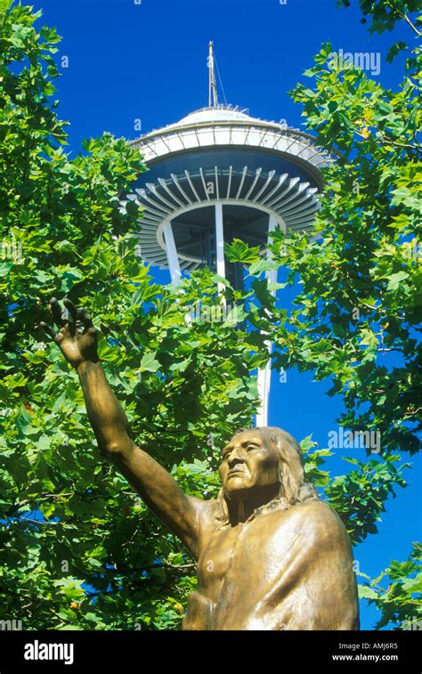 Space Needle with statue of Chief Seattle at base in Seattle WA against ...