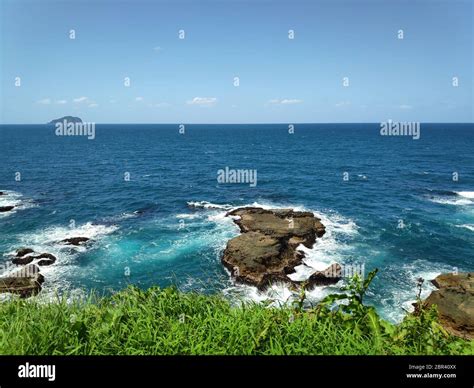 The beautiful beach with deep blue water and light blue sky and nice flower Stock Photo - Alamy