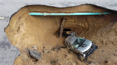 Massive Sinkhole Swallows Two Vehicles In Los Angeles Youtube