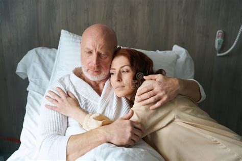 Mature Man And Woman Lying In Embrace Indoors Stock Photo Image Of Clinic Mature 278531658