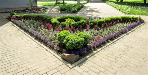 Landscaping A Flower Bed In The Shape Of A Triangle Stock Photo