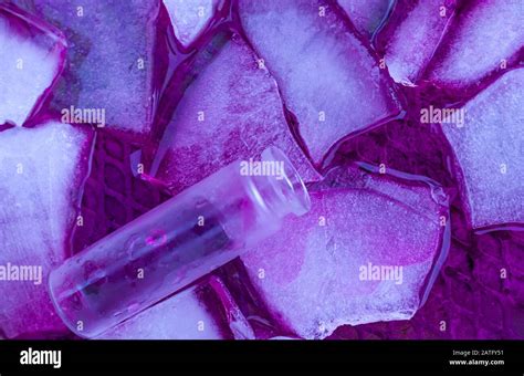 Still Life Overhead Photograph Of Glass Vial Floating On Frozen And Melting Ice Purple Haze