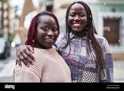 African American Women Friends Smiling Confident Hugging Each Other At