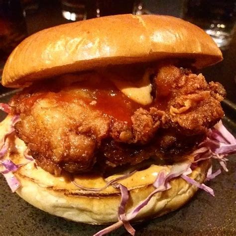 A Fried Chicken Sandwich With Cole Slaw On A Bun