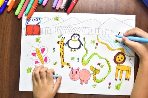 Premium Photo | Children use marker coloured pens to sketch imagined animals on white paper