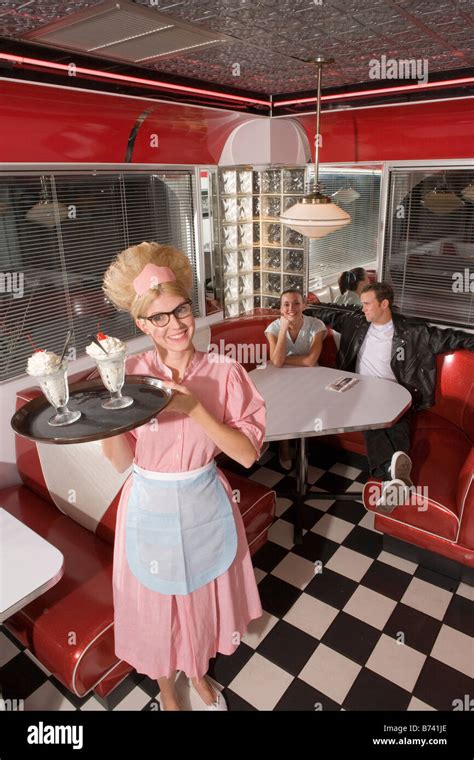 Happy Waitress In 1950s Style Uniform Serving Ice Cream Sundaes In