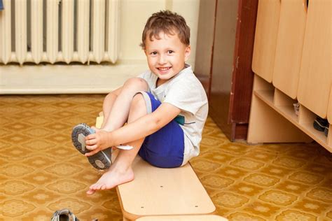 child putting  shoes