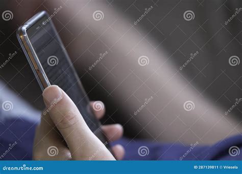 Man Scrolling And Reading Messages On His Smartphone Stock Image