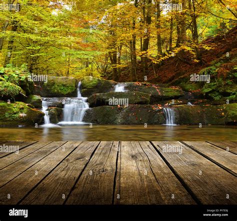 Empty Wooden Deck Table With Autumn Waterfall Background Ready For