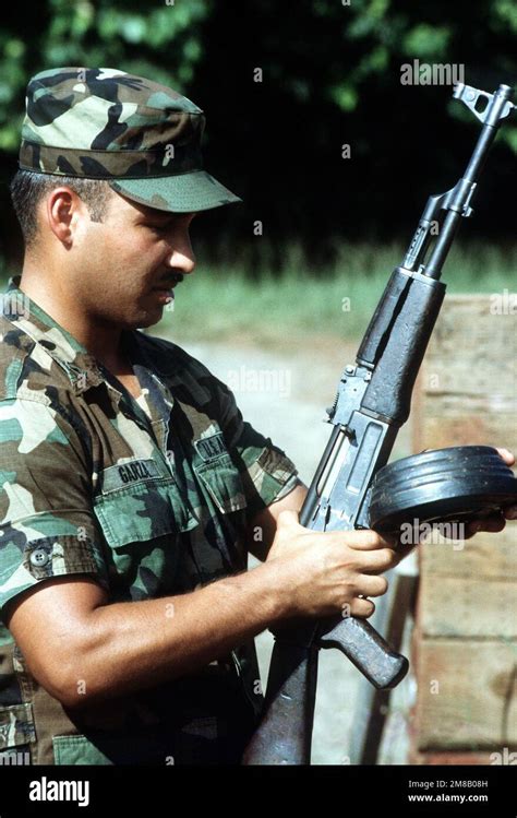 An Army Instructor Loads A Round Drum Magazine Into A Soviet Made Ak