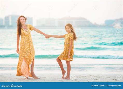 Beautiful Mother And Daughter At The Beach Enjoying Summer Vacation