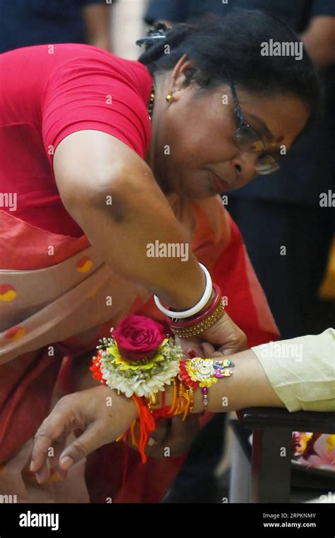 A Lady Tying Rakhi And Doing Other Rituals To Tripura Cm Professor Dr Manik Saha At His