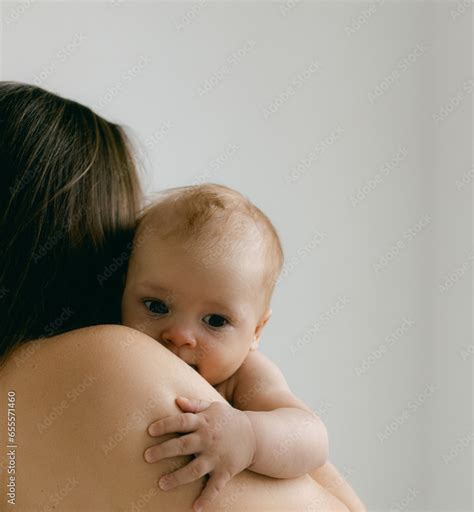 Nude Woman With Baby In Her Arms On Lighte Background Happy Motherhood And Breastfeeding