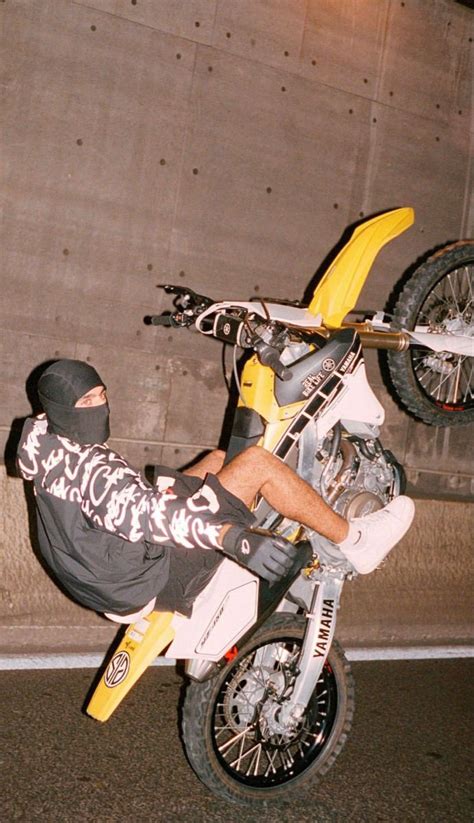 A Man Riding On The Back Of A Dirt Bike