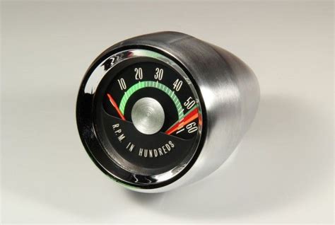 A Close Up Of A Speedometer On A White Surface