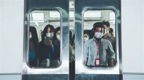 Crowd Of People Wearing Face Mask On A Crowded Public Subway Train