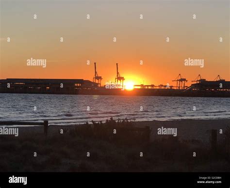 Sunset at the Port Melbourne beach Stock Photo - Alamy