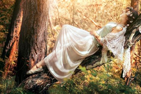 Premium Photo Close Up Of Naked Woman On Tree Trunk In Forest