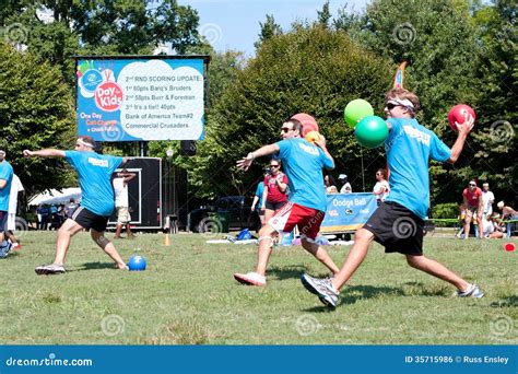 Three Men Throw in Unison at Outdoor Dodge Ball Game Editorial Photo ...