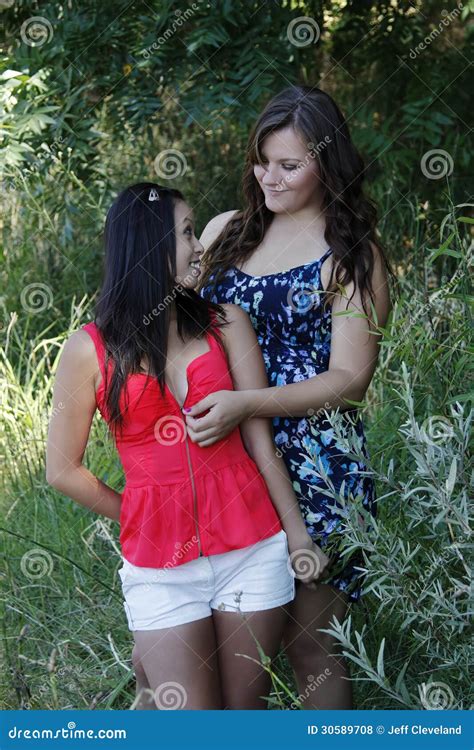 Two Women Outdoors Unzipping Top Caucasian Asian Stock Photo Image Of