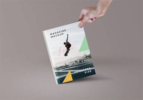 Hand holding Paper or Magazine Mockup - Mockup World