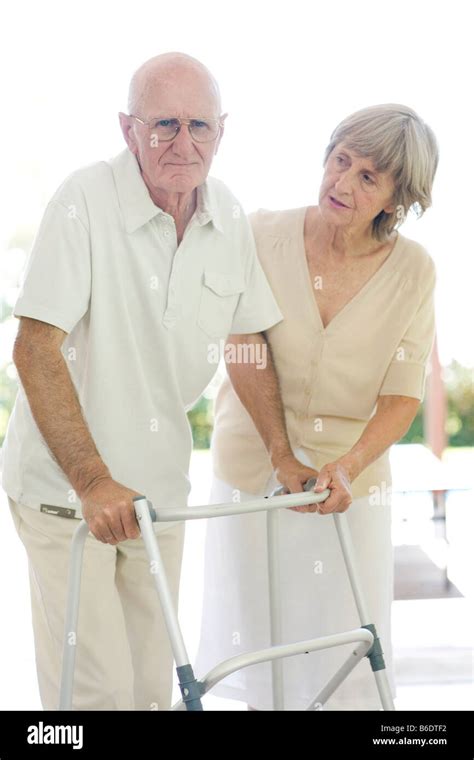 Walking Frame Woman Helping A Man With A Walking Frame Stock Photo Alamy