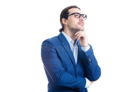 Thoughtful Businessman Keeps Hand Under Chin Looking Away Pensive