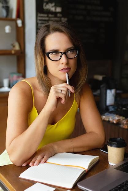 Premium Photo Thoughtful Woman Sitting At Table In Cafe