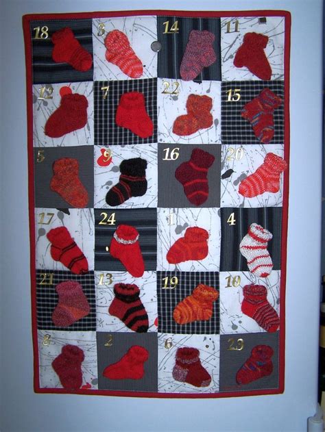 A Quilted Wall Hanging With Many Pairs Of Socks On It