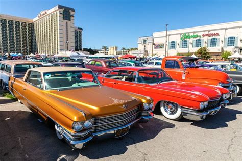 several classic cars are parked in a parking lot