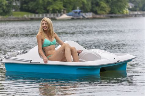 Beautiful Bikini Model Relaxing On A Boat By The Docks Stock Photo