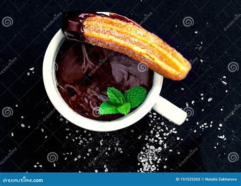 Churro With And Chocolate Sauce In A Cup On A Black Background Churro