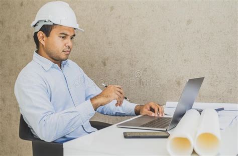 Asian Civil Engineer Working Planning Project With Laptop Stock Photo