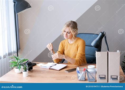 Pensive Female Administrative Assistant Reading Information Report In Notepad Stock Image