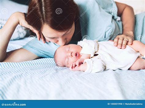 Mother Kissing Her Newborn Baby Stock Photo Image Of Home Childhood