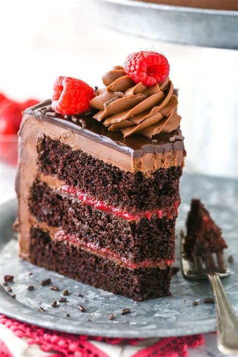 A Slice Of Chocolate Cake With Raspberries On Top