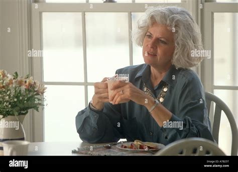 Mature Woman At Home Enjoying Breakfast Stock Photo Alamy