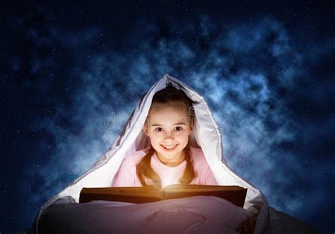 Happy Little Girl Reading Book in Bed Stock Image - Image of dark ...