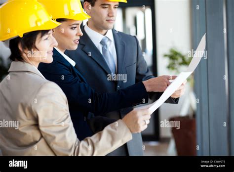 Group Of Construction Managers Looking At Blue Print Stock Photo Alamy