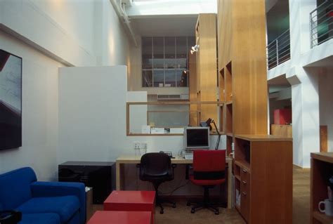 An Office With Blue And Red Furniture In It