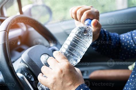 Asian Woman Driver Holding Bottle For Drink Water While Driving A Car Plastic Hot Water Bottle
