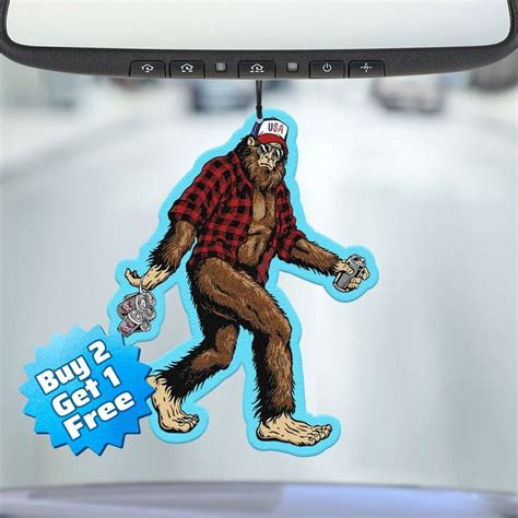 a sticker on the windshield of a car with a bigfoot wearing a hat