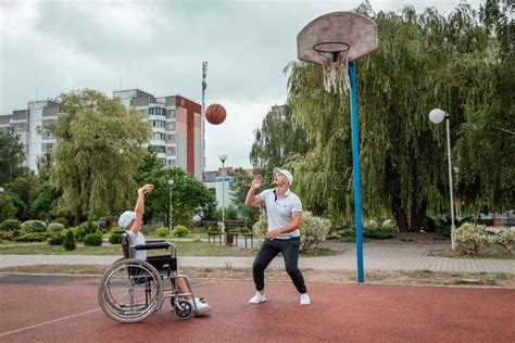 Dad Plays With His Disabled Son On The Sports Ground Concept