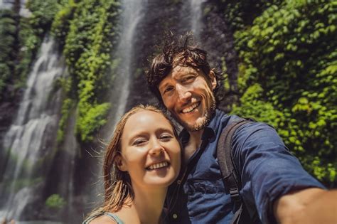 Premium Photo Loving Couple At The Sekumpul Waterfalls In Jungles On Bali Island Indonesia