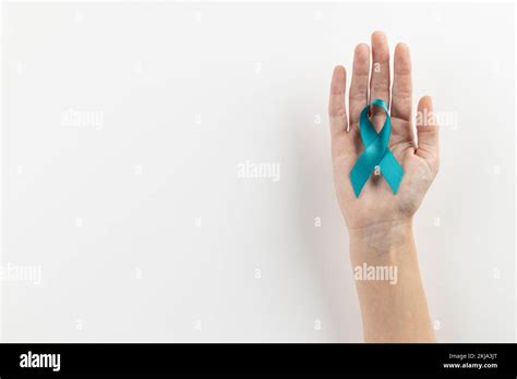 Composition Of Hand Holding Blue Ovarian Cancer Awareness Ribbon On