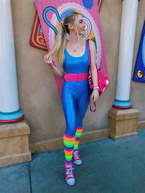 a woman standing in front of a building wearing colorful tights