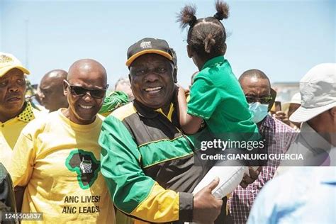 South African President Cyril Ramaphosa carries a child as arrives ...